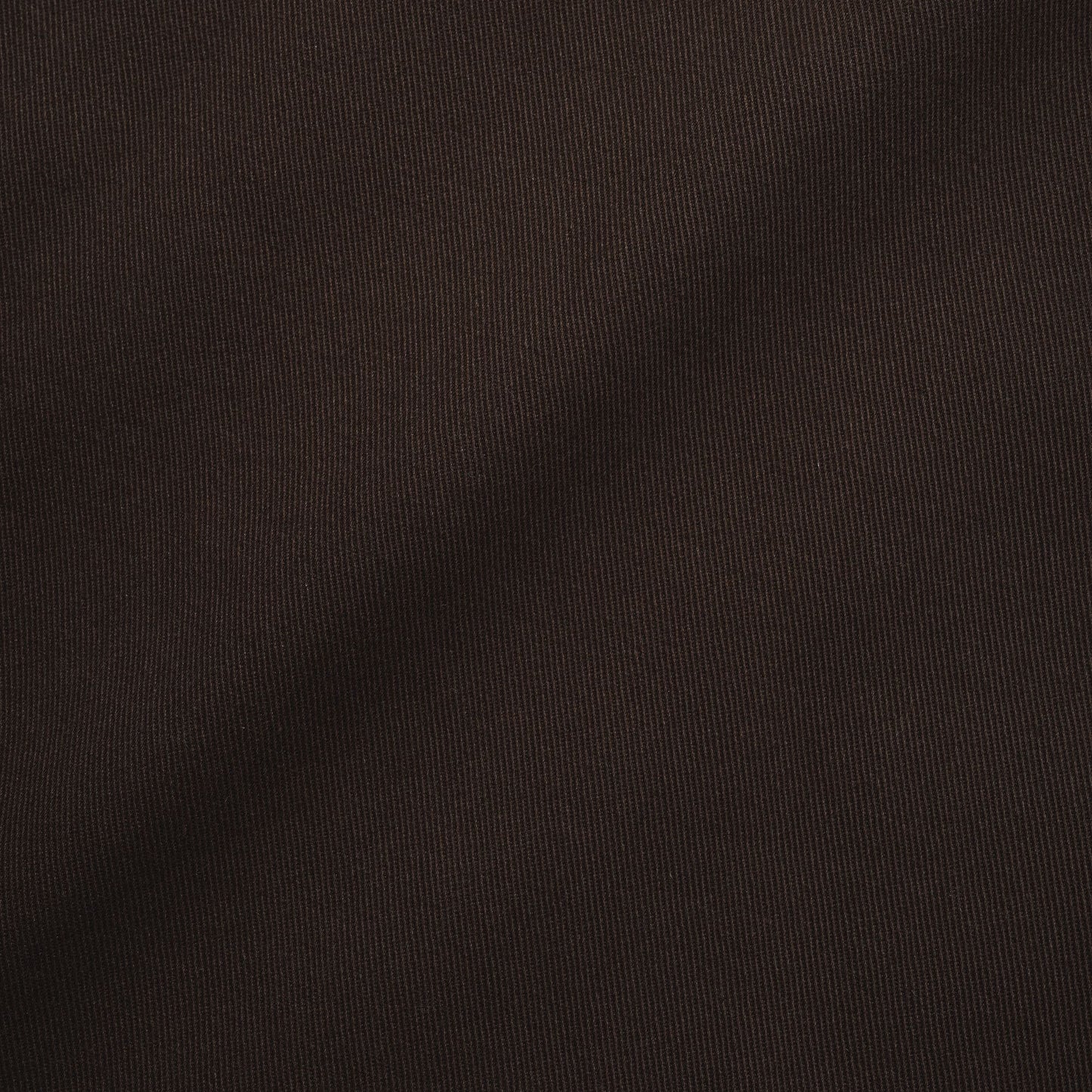 A close-up of dark brown ribbed knit fabric with soft diagonal folds and shadows.