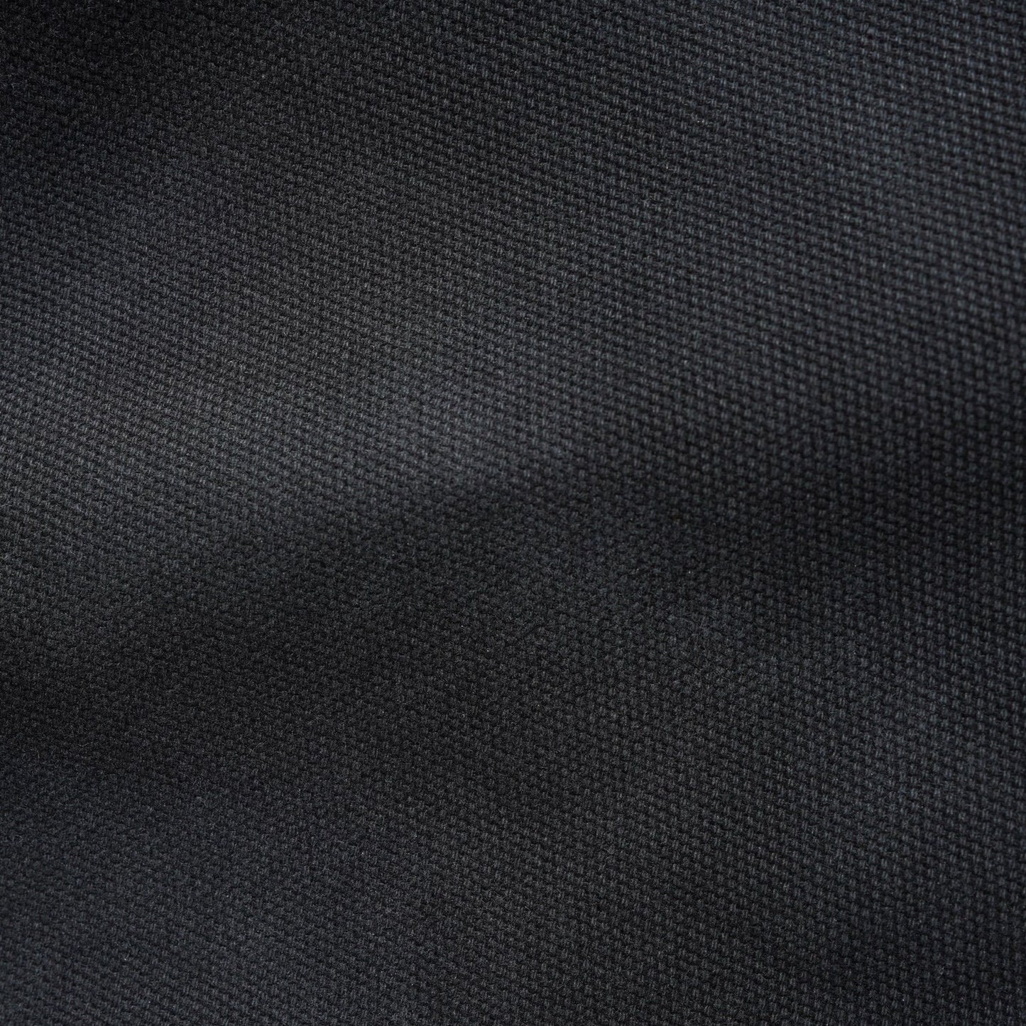 A close-up of dark charcoal gray woven fabric texture with soft folds and a fine ribbed pattern.