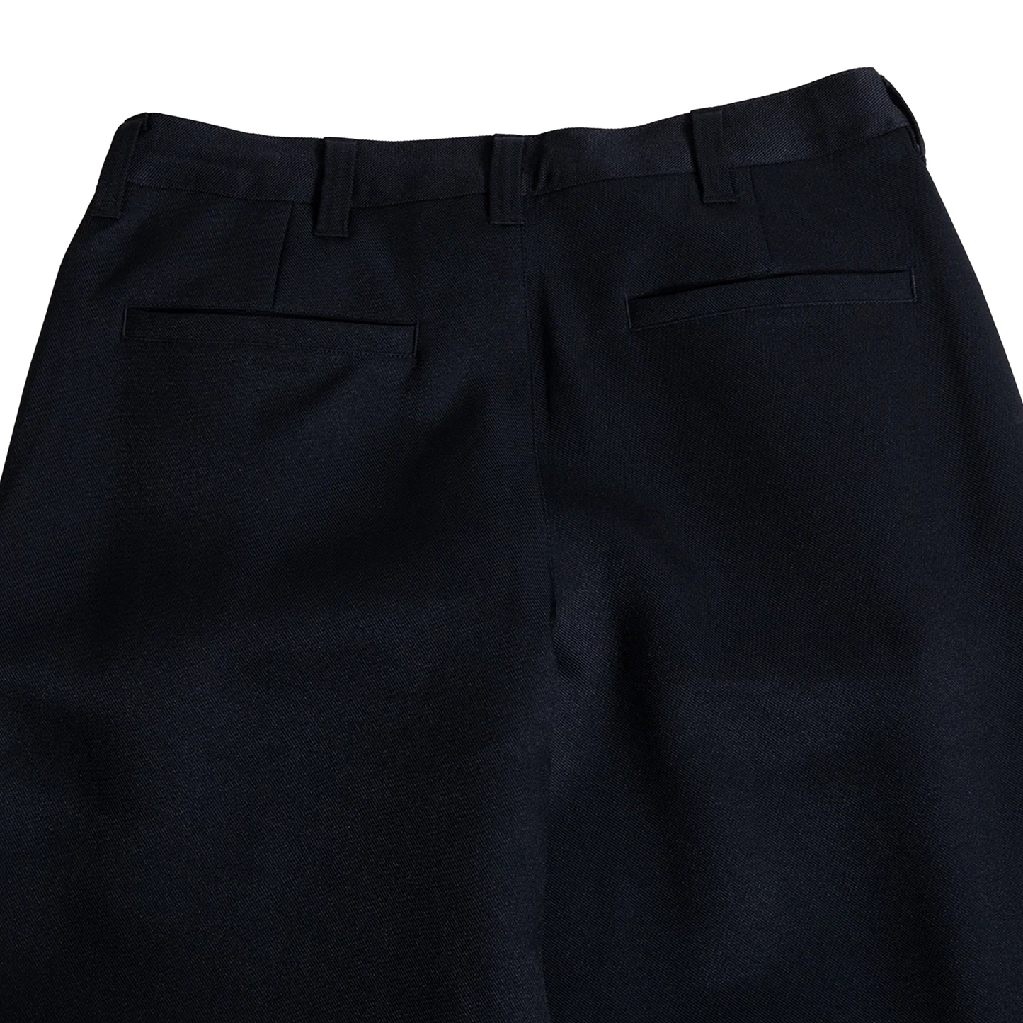 Close-up back view of black dress pants showing the waistband, belt loops, and two rear welt pockets on a white background.