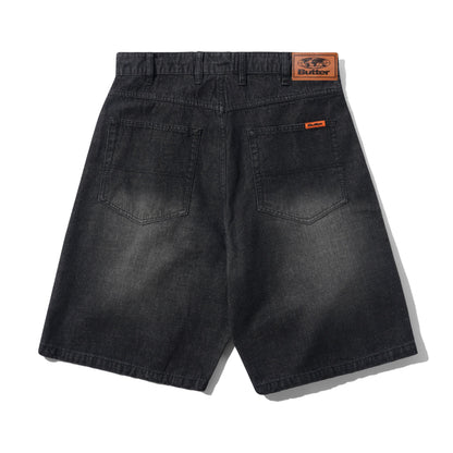 Back view of dark gray washed denim shorts with a visible Butter brand patch on the waistband and a small orange brand tab on the back pocket.