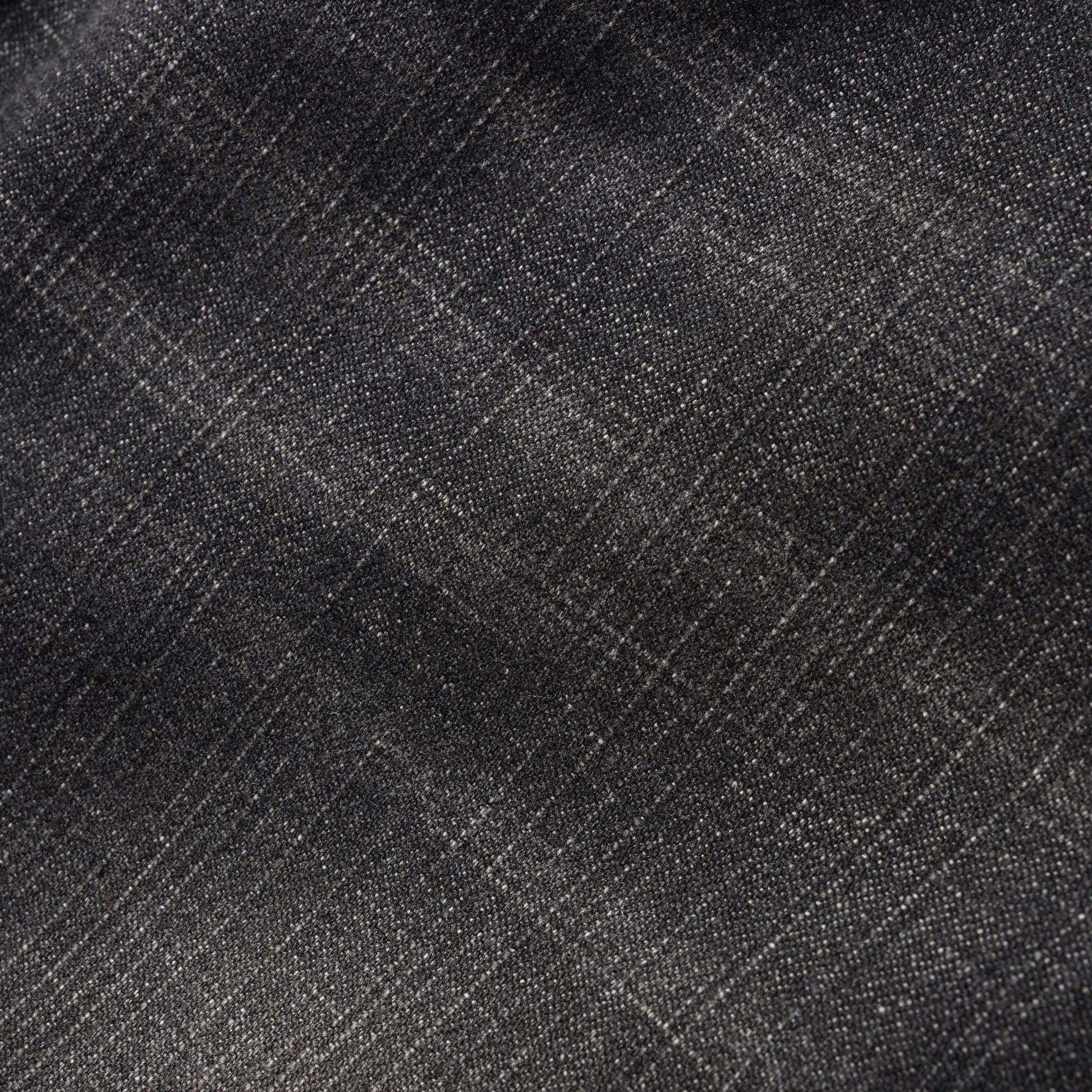 A close-up of dark charcoal gray fabric with a subtle woven texture and faint diagonal plaid lines.