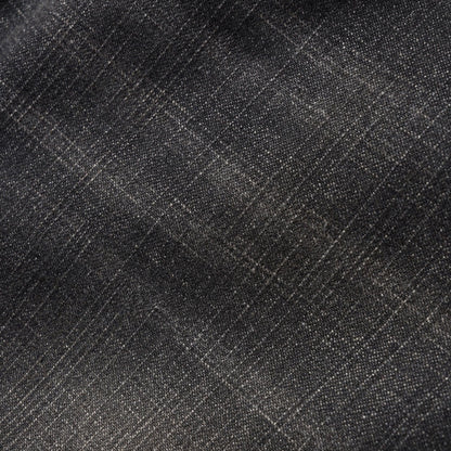 A close-up of dark charcoal gray fabric with a subtle woven texture and faint diagonal plaid lines.