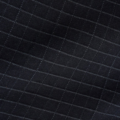 Close-up of a black fabric with a subtle windowpane check pattern in light gray.