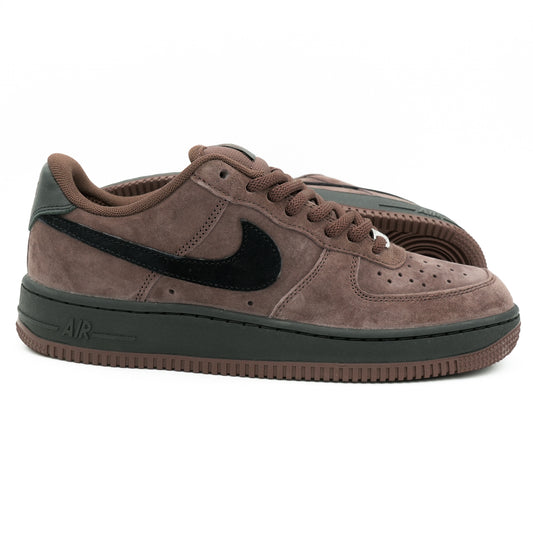 A pair of Nike Air Force 1 Low sneakers in brown suede with a black Swoosh and black accents on the heel, collar lining, and midsole.