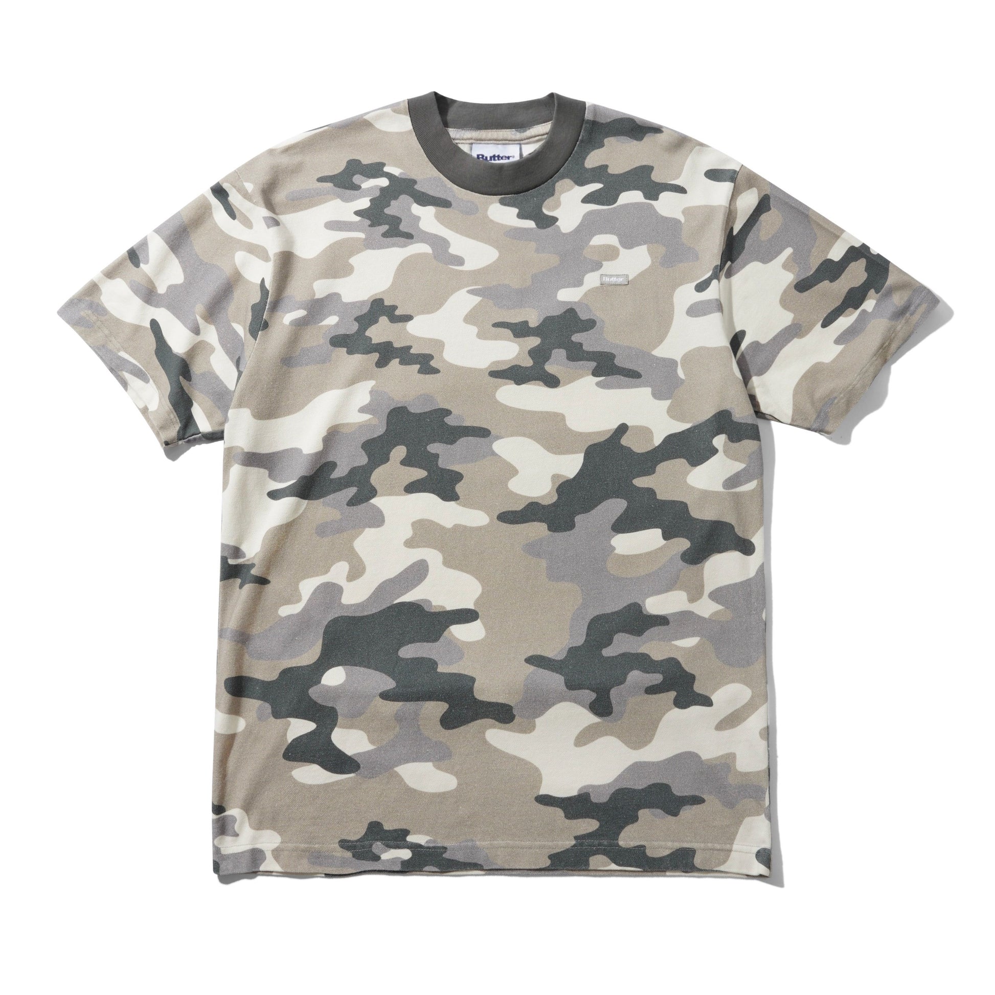 A short-sleeve crewneck t-shirt featuring a classic camouflage pattern in shades of beige, gray, and dark charcoal, laid flat against a white background.