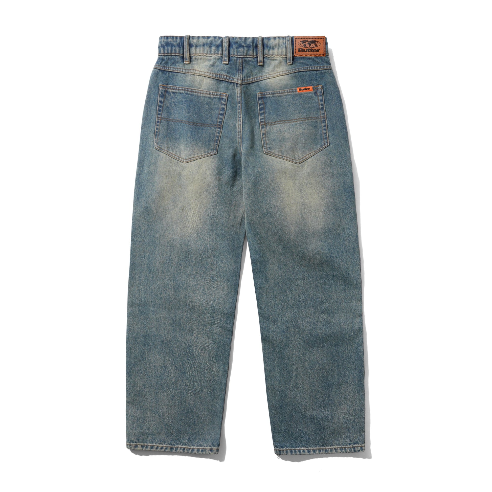 Back view of a pair of light blue denim jeans with a faded wash, featuring two back pockets and a brown leather patch on the waistband.