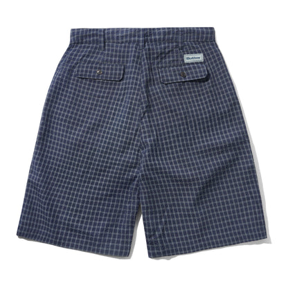 A pair of blue and white checkered shorts shown from the back, featuring two buttoned flap pockets and a small white brand label on the upper right side.