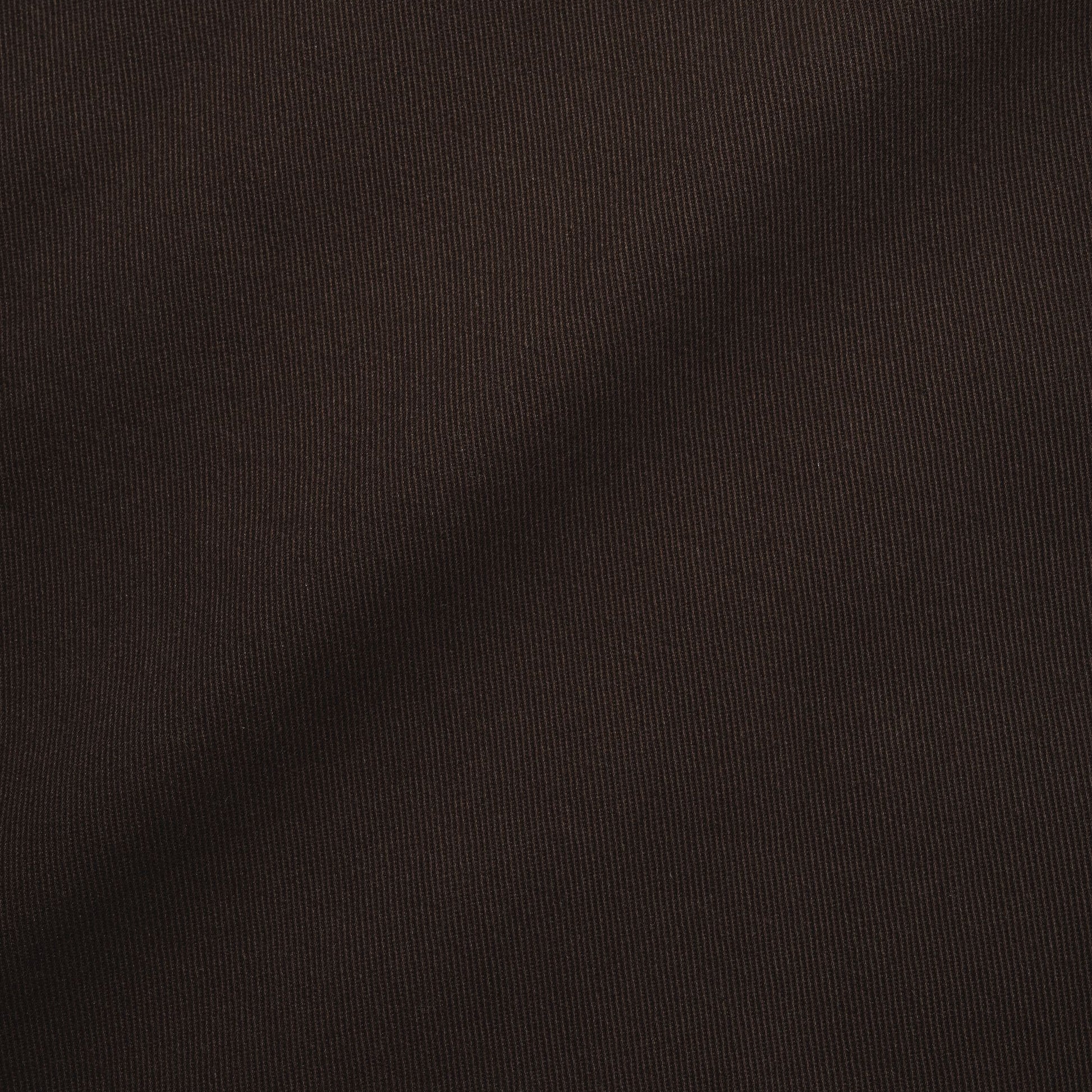 A close-up of dark brown ribbed knit fabric with soft diagonal folds and shadows.