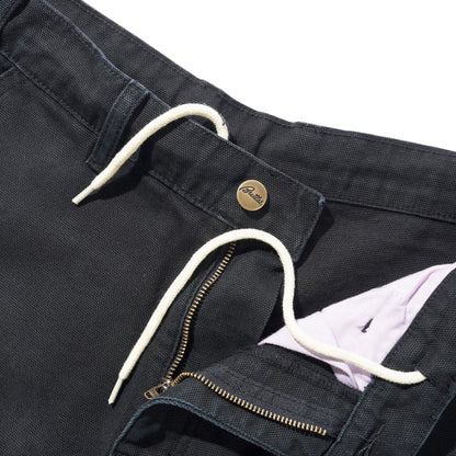Close-up of dark charcoal gray denim pants showing the waistband, white drawstring, brass button, and zipper pocket detail.